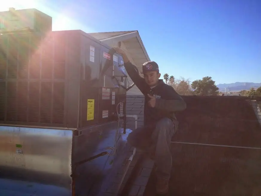 HVAC technician performing HVAC Inspection on a rooftop unit in Hartford